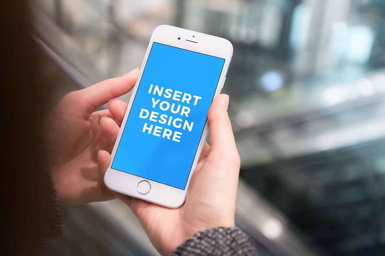 An iPhone showing the message "Insert your design here"